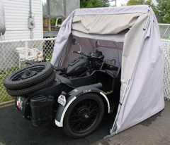 Antique military motorcycle sidecar in a trike model bike barn cover